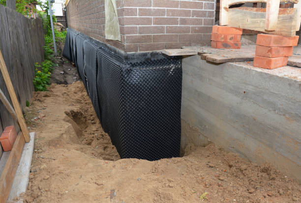 SJ Waterproofing Pros technician performing targeted Exterior Waterproofing assessment in Lyons, MI